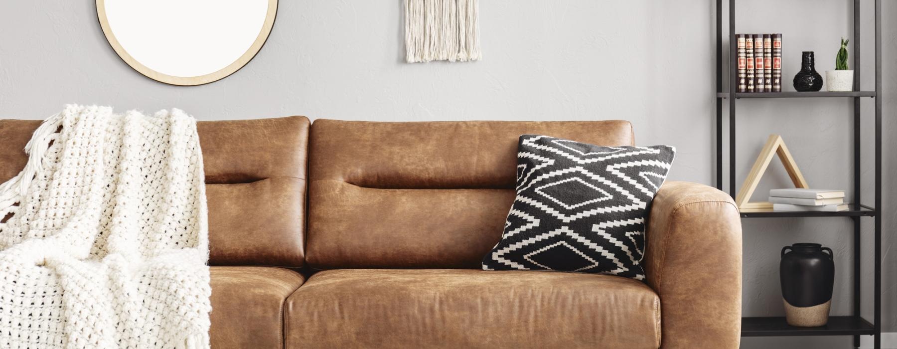 a couch with a mirror above it