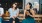 women sitting on a bench with drinks