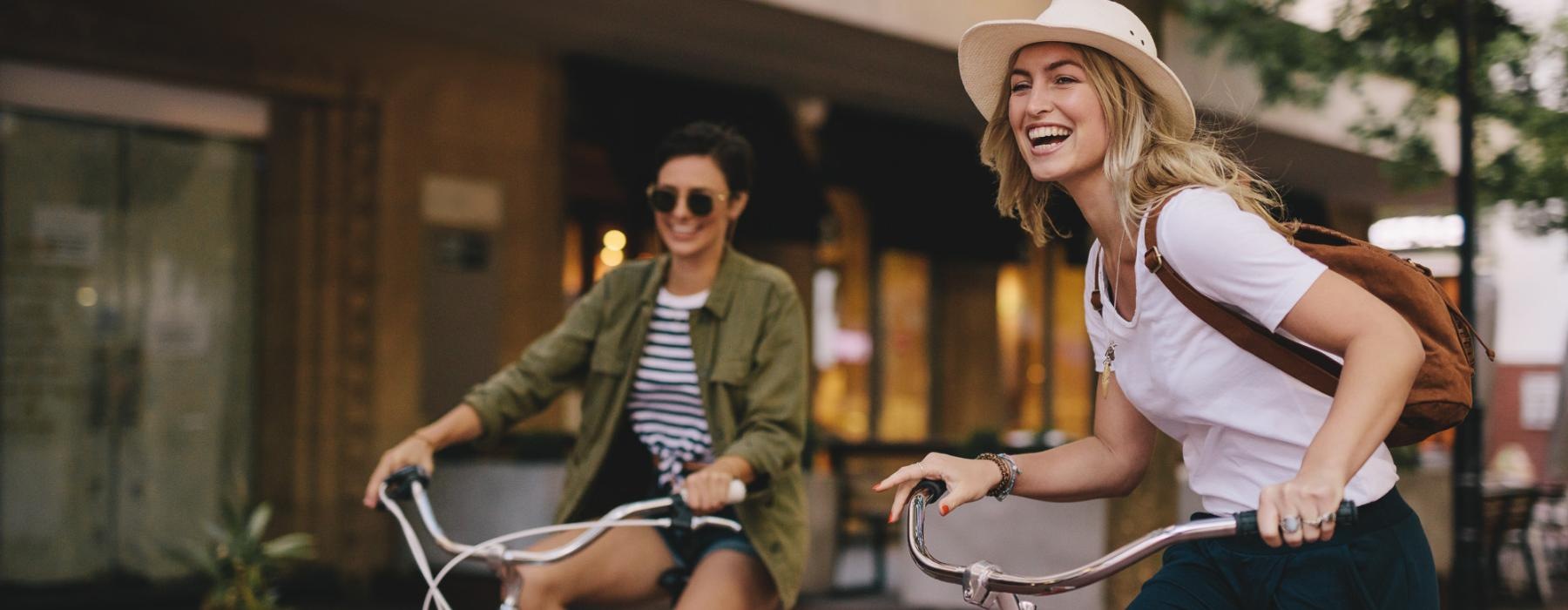 a two women riding bikes