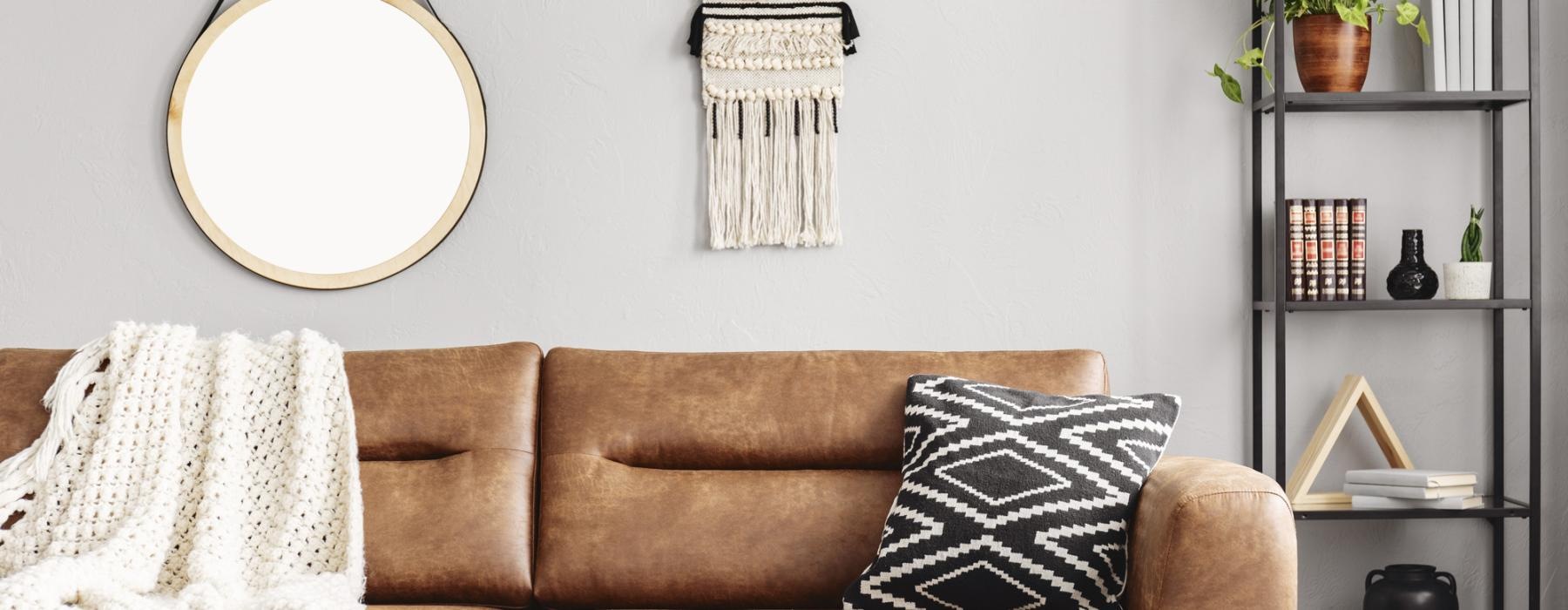 a couch with a mirror above it